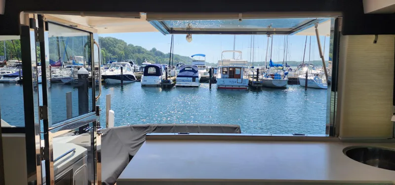 Slide: The Image of View from 2014 Cruisers Cantius yacht interior overlooking marina with docked boats. - 8