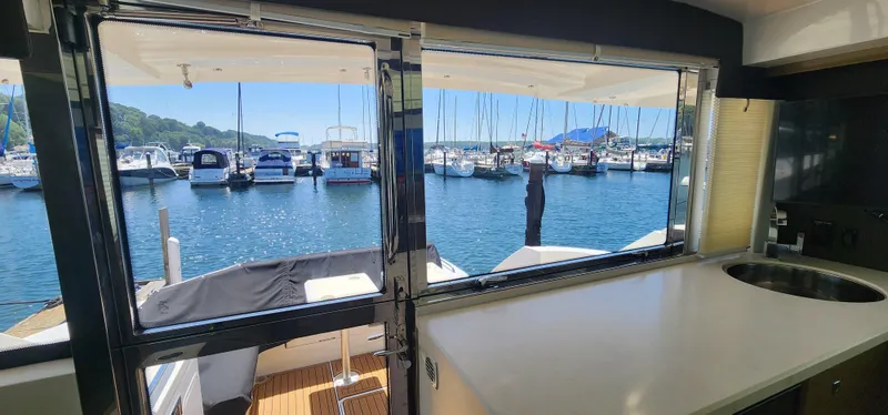 Slide: The Image of Interior view from a 2014 Cruisers Cantius yacht, overlooking a marina with docked boats. - 9