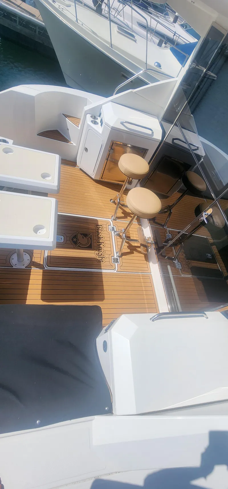 Slide: The Image of 2014 Cruisers Cantius yacht deck with seating and tables, featuring teak flooring. - 12