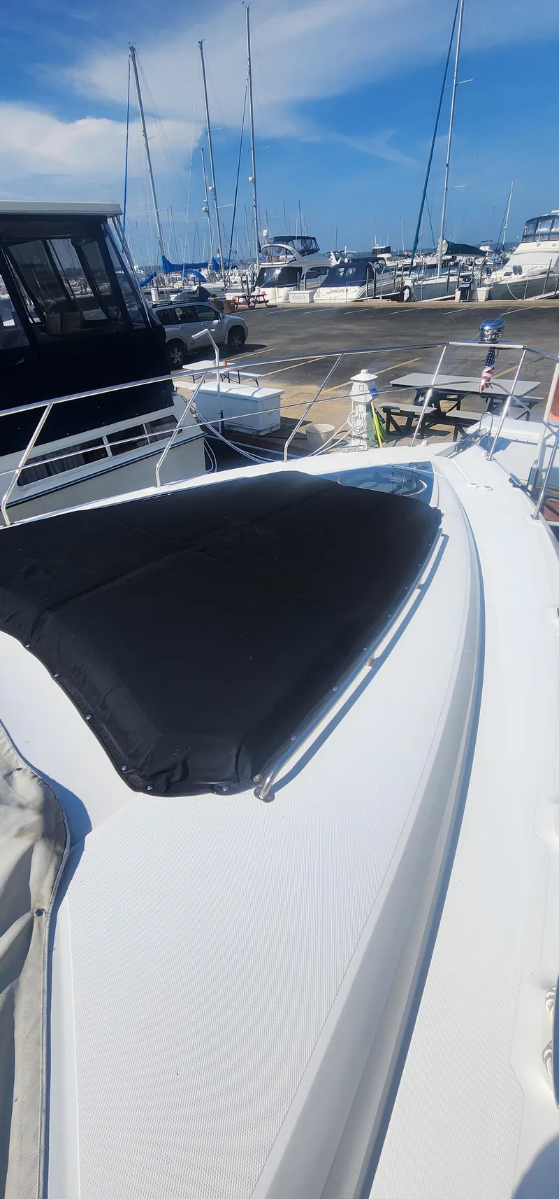 Slide: The Image of 2014 Cruisers Cantius yacht docked at a marina under a clear blue sky. - 16