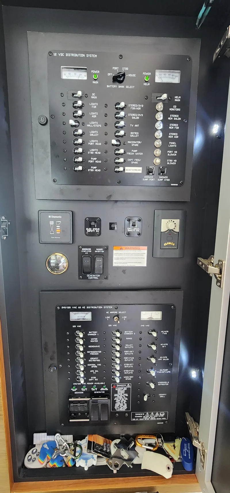 Slide: The Image of Electrical panel inside a 2014 Cruisers Cantius boat, featuring switches and controls. - 17