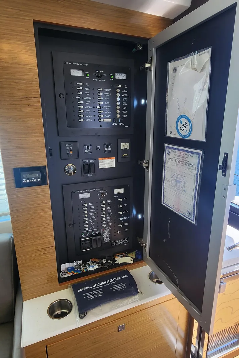 Slide: The Image of Electrical panel inside a 2014 Cruisers Cantius yacht, featuring marine documentation and controls. - 18