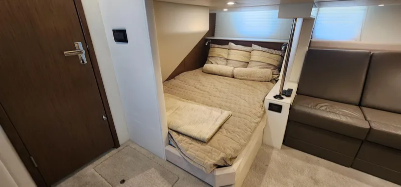 Slide: The Image of 2014 Cruisers Cantius cabin interior with cozy bed and seating area. - 26