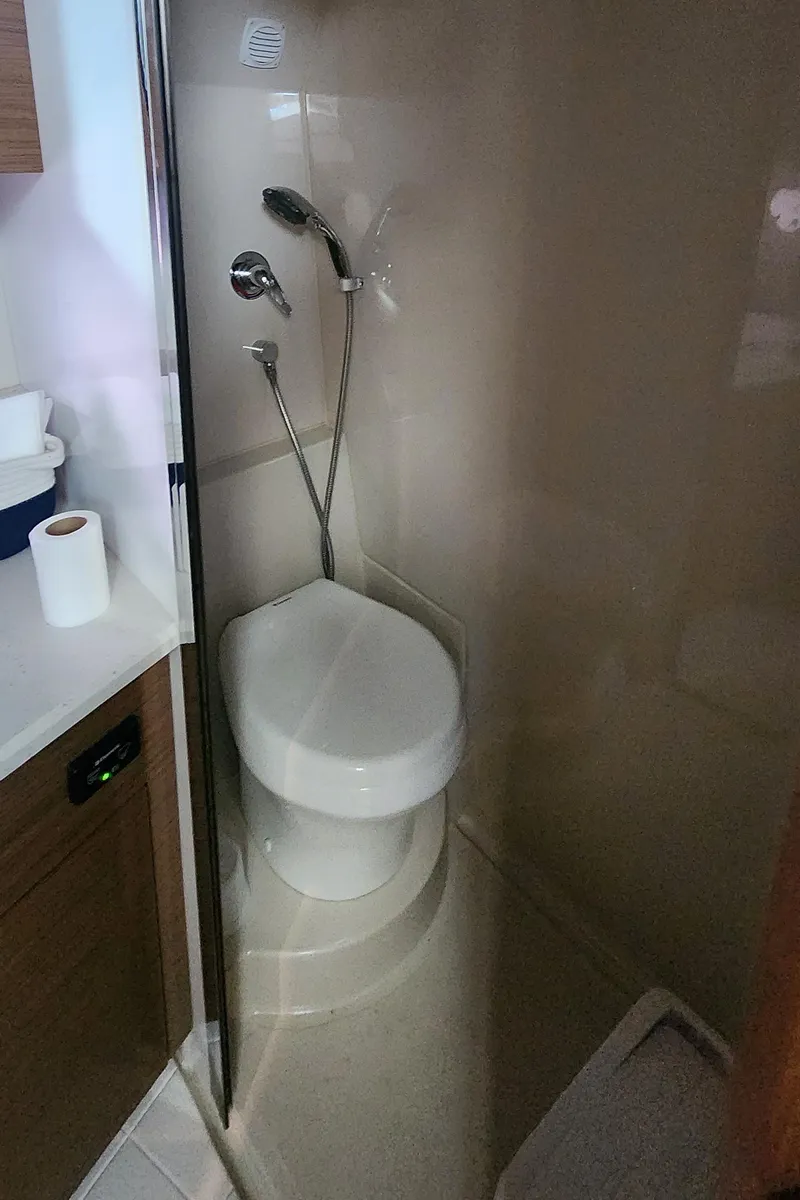 Slide: The Image of 2014 Cruisers Cantius yacht bathroom with compact toilet and shower. - 33