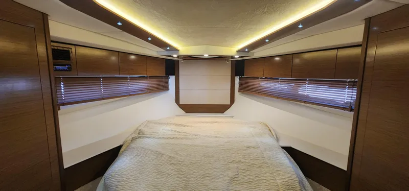 Slide: The Image of Luxurious 2014 Cruisers Cantius yacht cabin with modern wood finishes and ambient lighting. - 34