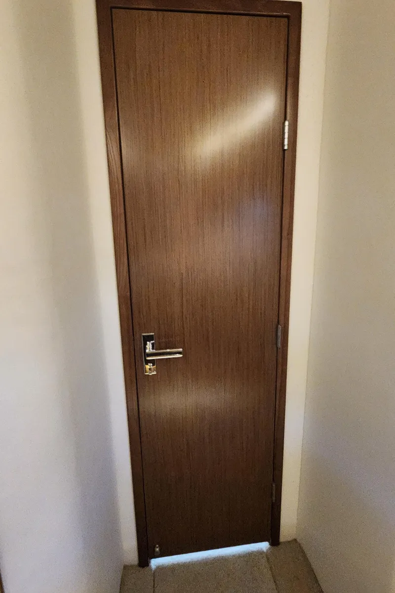 Slide: The Image of Wooden door with modern handle on a 2014 Cruisers Cantius yacht. - 36