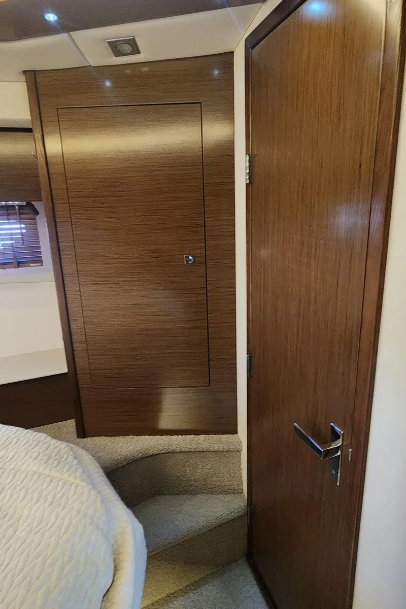 Slide: The Image of Interior of 2014 Cruisers Cantius yacht with wooden door and cozy bedroom. - 41