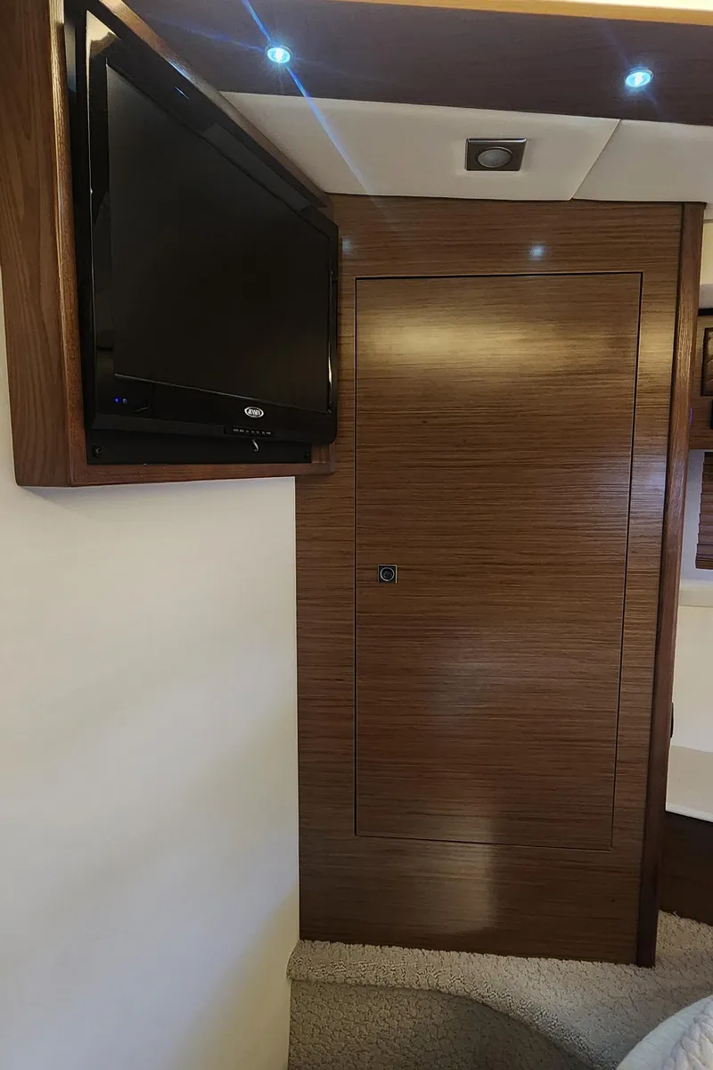 Slide: The Image of 2014 Cruisers Cantius interior with wall-mounted TV and wooden paneling. - 42