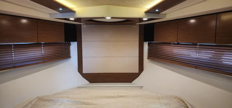 Slide: The Image of Luxurious 2014 Cruisers Cantius yacht interior with wood paneling and cozy bedding. - 45