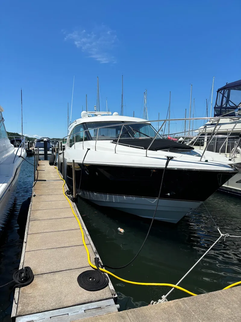 Slide: The Image of 2014 Cruisers Cantius yacht docked at marina under clear blue sky. - 5