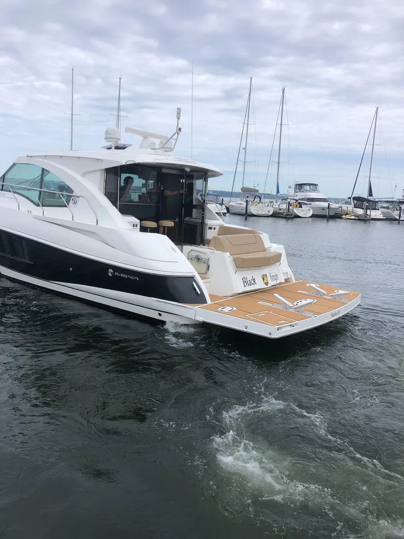 Slide: The Image of 2014 Cruisers Cantius yacht docked in a marina with sailboats in the background. - 6