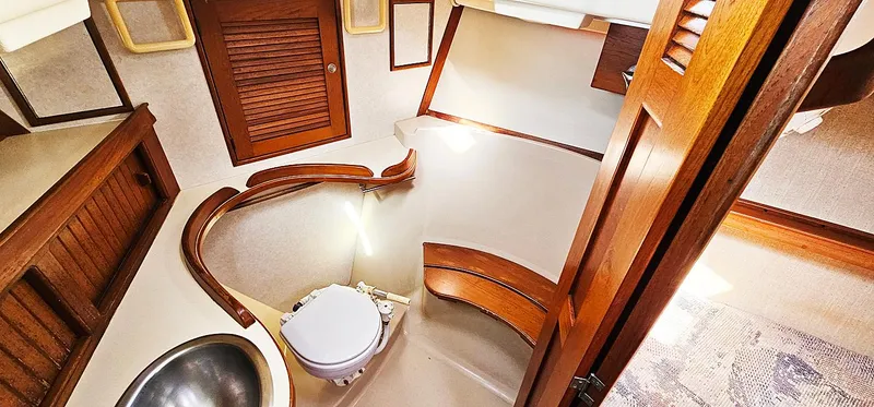 Slide: The Image of 1997 Island Packet 40 yacht bathroom with wooden accents and compact design. - 12