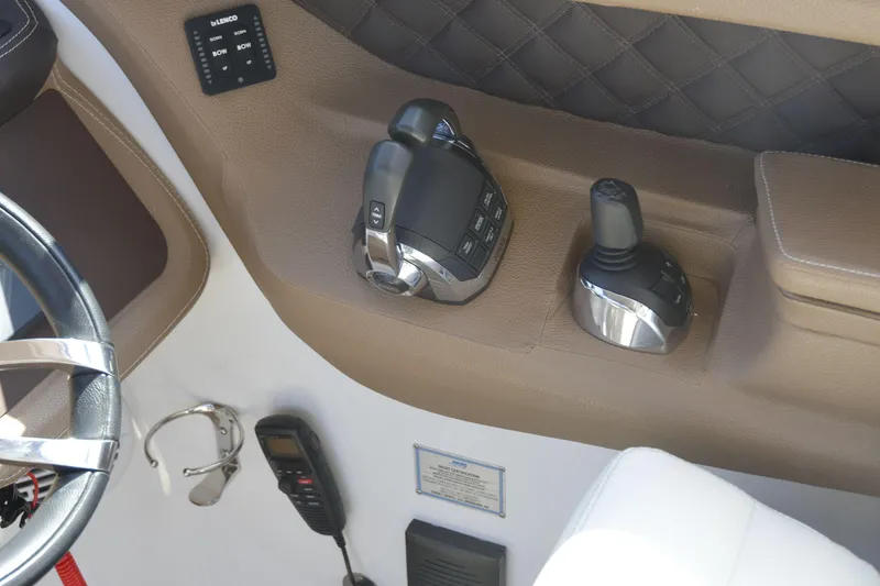 Slide: The Image of Control panel of a 2018 Cobalt R35 boat with steering and throttle controls. - 11