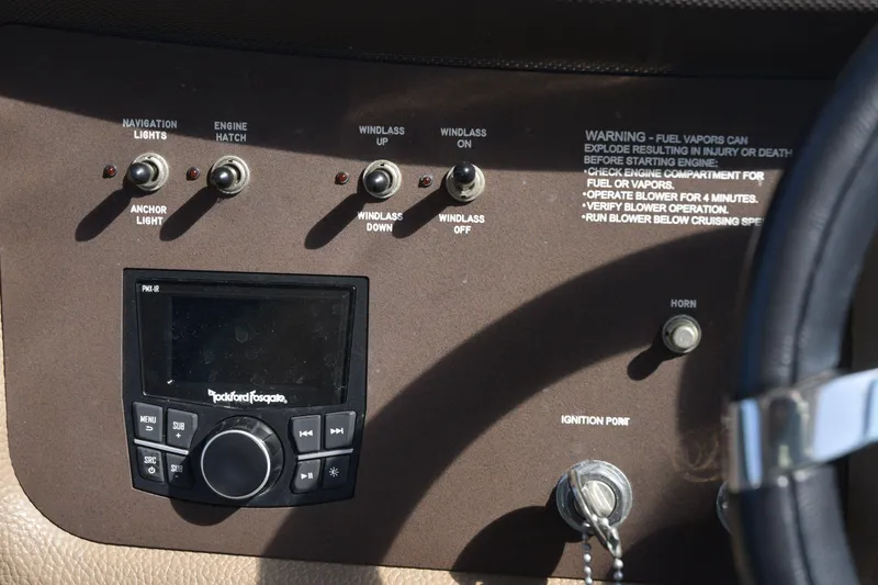 Slide: The Image of Control panel of a 2018 Cobalt R35 boat with switches and stereo system. - 12