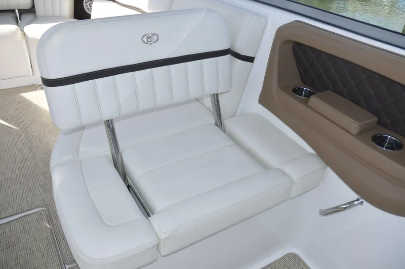 Slide: The Image of 2018 Cobalt R35 boat interior with white leather seating and cup holders. - 14