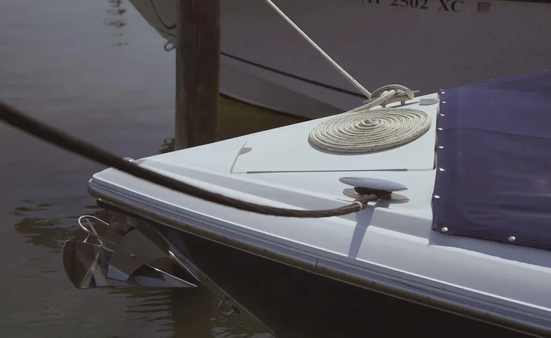 Slide: The Image of Bow of a 2018 Cobalt R35 boat docked, featuring a coiled rope and anchor. - 18