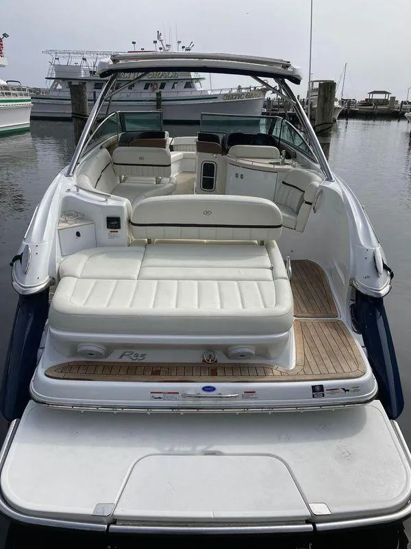 Slide: The Image of 2018 Cobalt R35 boat with spacious seating, docked at a marina. - 6