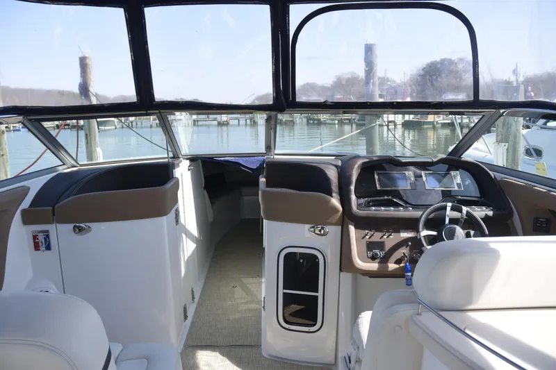 Slide: The Image of Interior view of a 2018 Cobalt R35 boat, featuring a modern helm and spacious seating. - 9