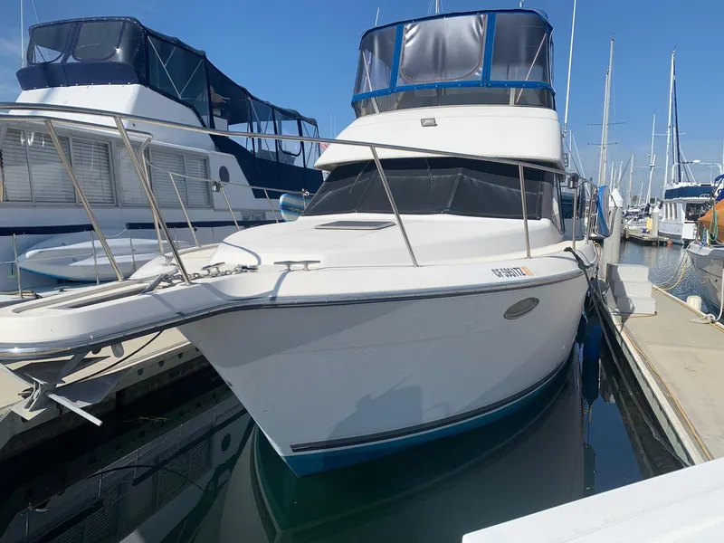 Slide: The Image of 1992 Carver 33 Aft Cabin yacht docked at marina, clear blue sky. - 2