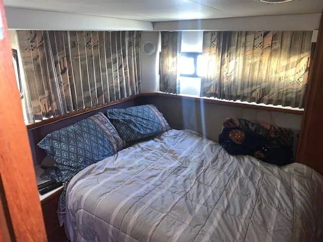 Slide: The Image of Cozy bedroom in 1992 Carver 33 Aft Cabin yacht with patterned curtains and bedding. - 21