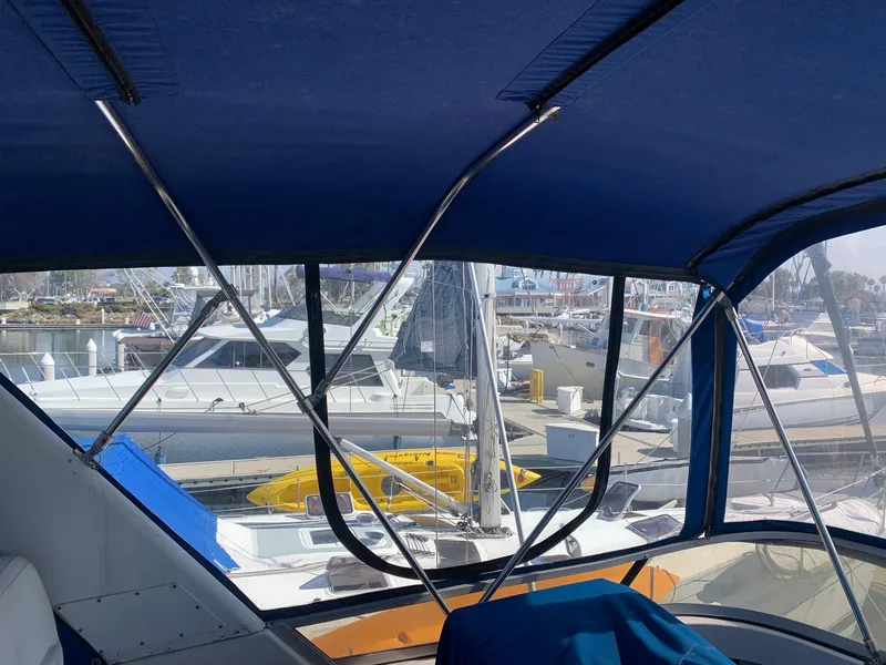 Slide: The Image of 1992 Carver 33 Aft Cabin interior view with marina backdrop. - 30