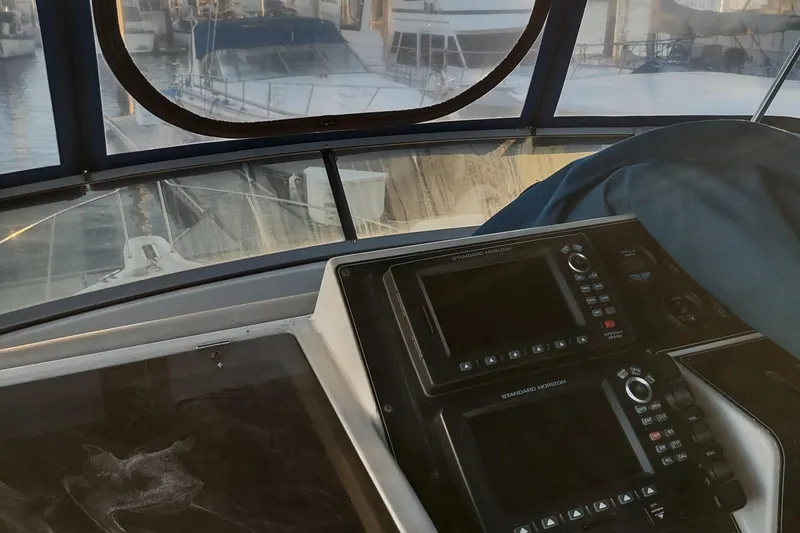 Slide: The Image of 1992 Carver 33 Aft Cabin helm with navigation equipment, docked at marina. - 41