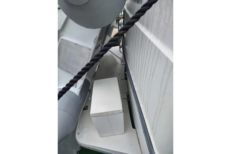 Slide: The Image of 1992 Carver 33 Aft Cabin Motor Yacht deck with storage box and rope detail. - 46