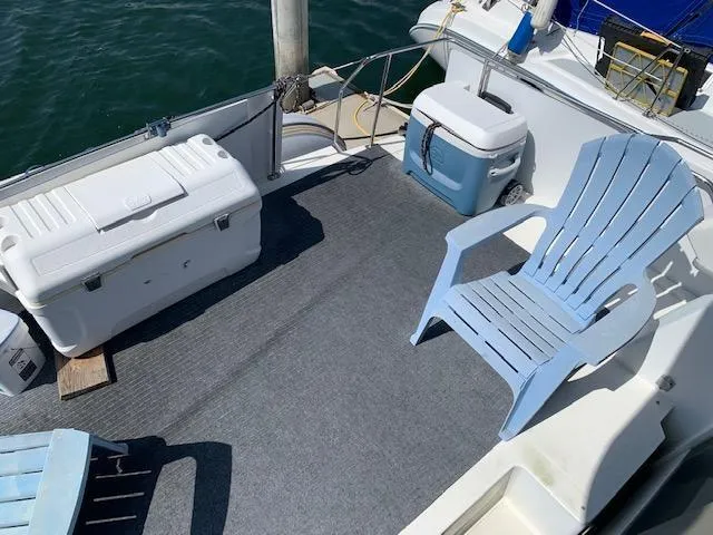 Slide: The Image of 1992 Carver 33 Aft Cabin deck with coolers and blue chairs. - 5