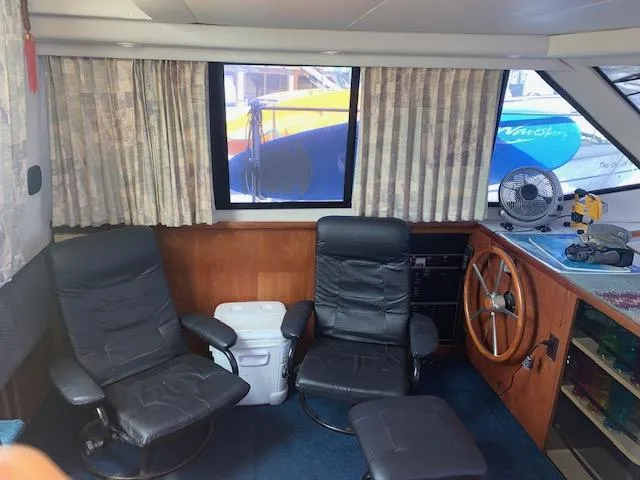 Slide: The Image of Interior of 1992 Carver 33 Aft Cabin with chairs, window, and steering wheel. - 9