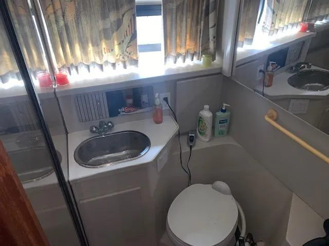 Slide: The Image of Bathroom interior of 1992 Carver 33 Aft Cabin yacht with sink and toilet. - 18