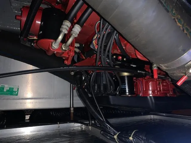 Slide: The Image of Engine compartment of a 1992 Carver 33 Aft Cabin boat, showcasing mechanical components. - 24