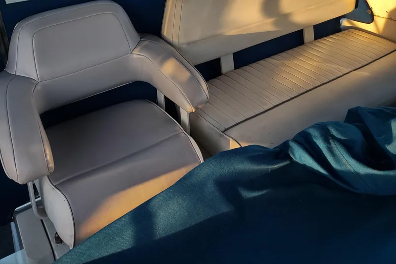 Slide: The Image of 1992 Carver 33 Aft Cabin interior with gray seating and blue cover. - 3