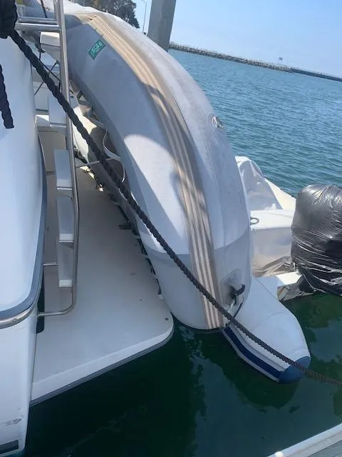 Slide: The Image of 1992 Carver 33 Aft Cabin with inflatable boat docked by the water. - 33