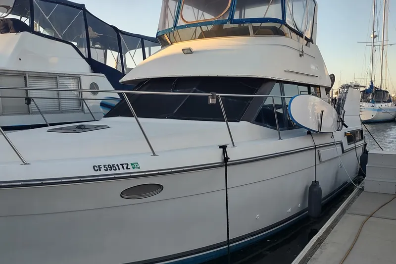 Slide: The Image of 1992 Carver 33 Aft Cabin yacht docked at marina, side view. - 36