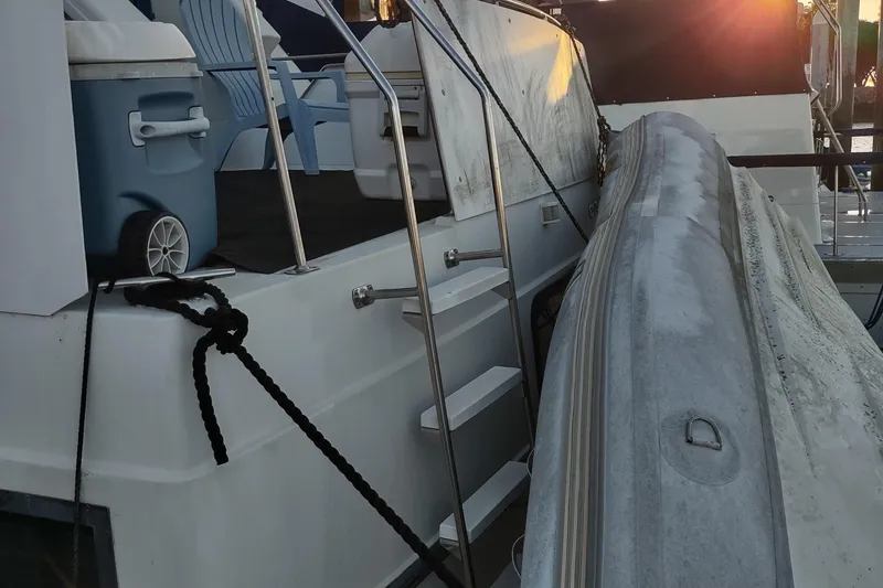 Slide: The Image of 1992 Carver 33 Aft Cabin yacht with inflatable boat and sunset in background. - 39