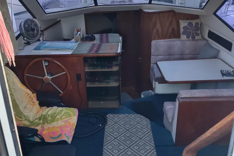 Slide: The Image of 1992 Carver 33 Aft Cabin interior with helm, seating, and table. Cozy nautical design. - 42