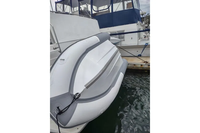 Slide: The Image of 1992 Carver 33 Aft Cabin Motor Yacht docked with inflatable dinghy attached. - 45
