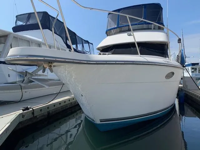 Slide: The Image of 1992 Carver 33 Aft Cabin boat docked at marina, front view. - 7