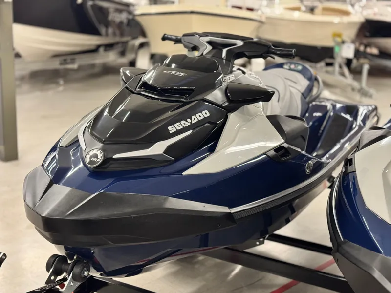 Slide: The Image of 2023 Sea-Doo GTX LTD 300 jet ski in showroom, featuring sleek design and modern features. - 3