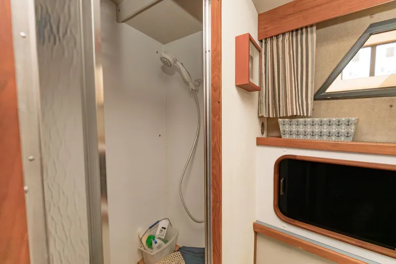 Slide: The Image of 1987 Carver 3697 Mariner bathroom with shower, window, and wooden accents. - 20