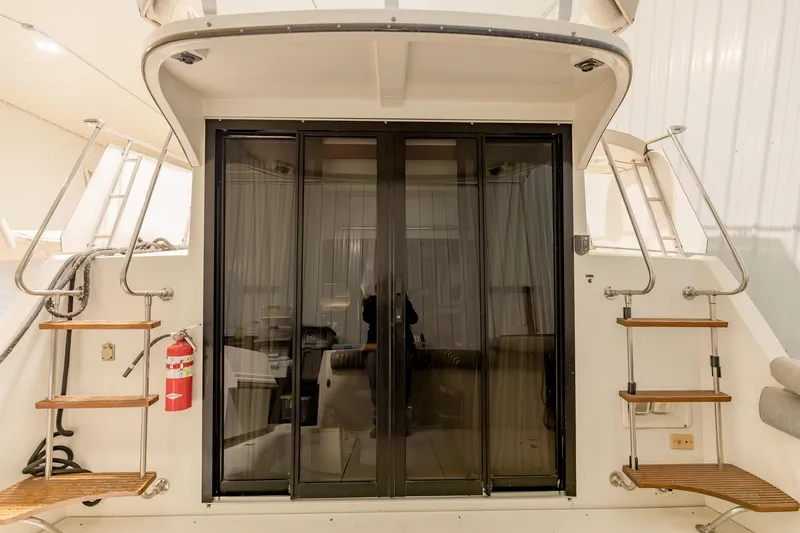 Slide: The Image of 1987 Carver 3697 Mariner yacht with sliding glass doors and wooden steps. - 6