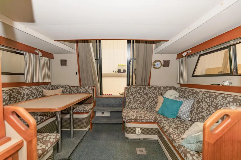 Slide: The Image of Interior of 1987 Carver 3697 Mariner yacht with cozy seating and dining area. - 8