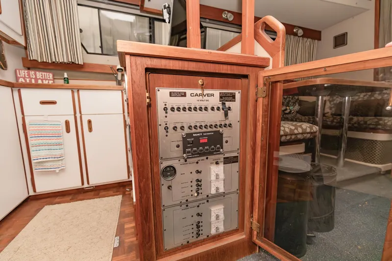 Slide: The Image of 1987 Carver 3697 Mariner interior with control panel and cozy cabin furnishings. - 13