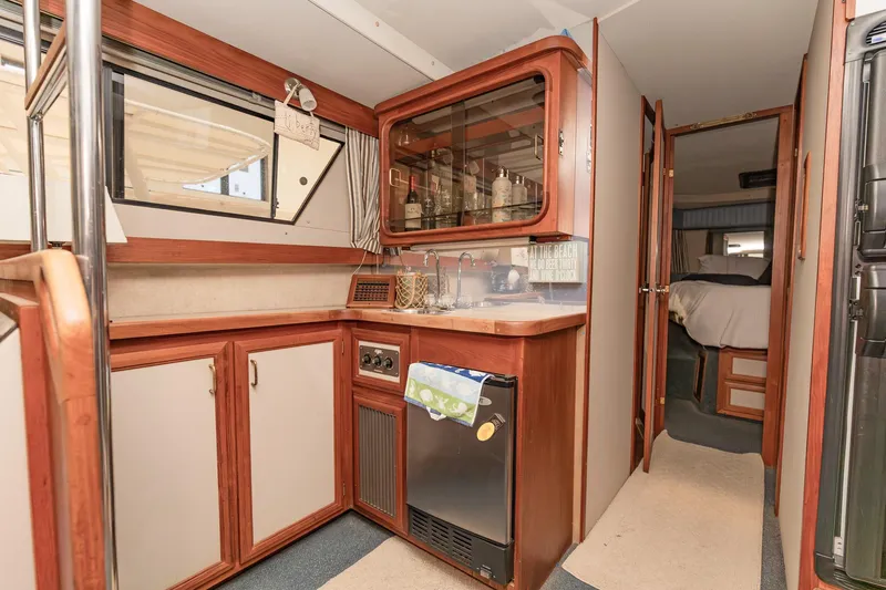 Slide: The Image of 1987 Carver 3697 Mariner interior with compact kitchen and cozy cabin. - 16