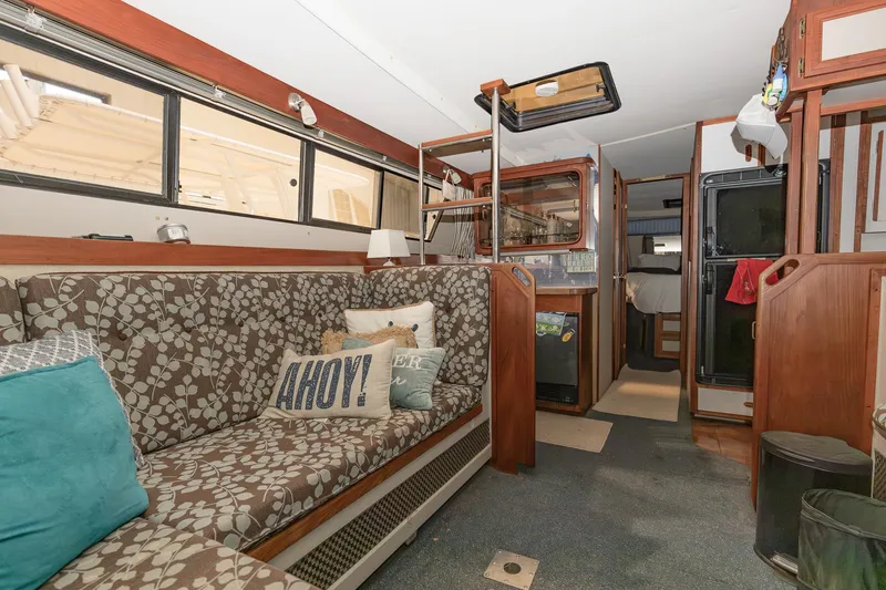 Slide: The Image of Interior of 1987 Carver 3697 Mariner yacht with cozy seating and nautical decor. - 18