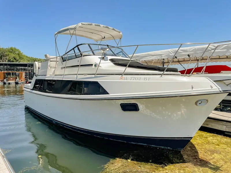 Slide: The Image of 1987 Carver 3697 Mariner boat docked in sunny marina setting. - 2