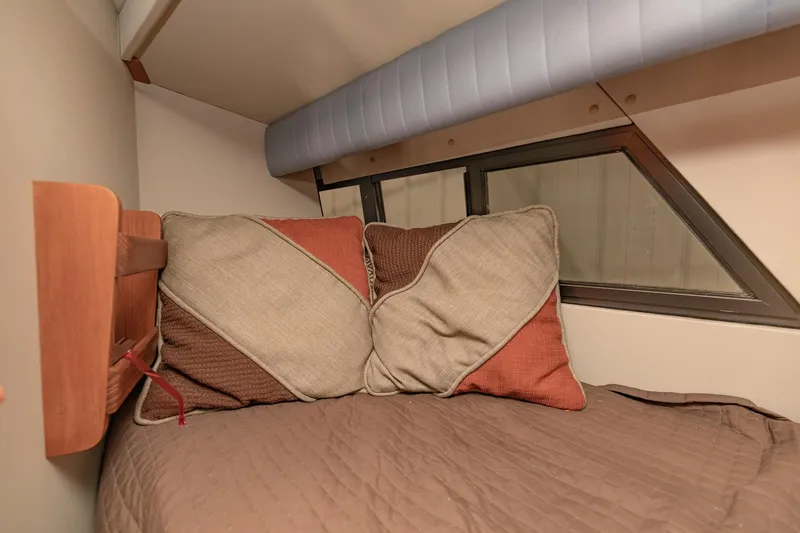Slide: The Image of Cozy cabin interior of 1987 Carver 3697 Mariner with decorative pillows and bedding. - 23