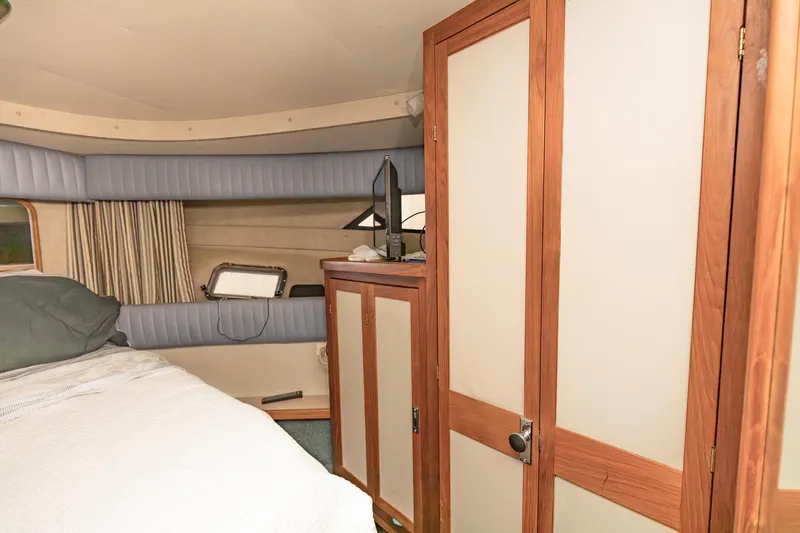 Slide: The Image of Interior of 1987 Carver 3697 Mariner yacht with wood accents and cozy sleeping area. - 25