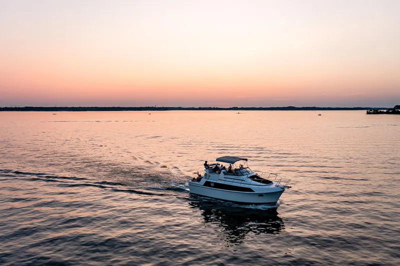 Slide: The Image of 1987 Carver 3697 Mariner cruising at sunset on calm waters. - 5