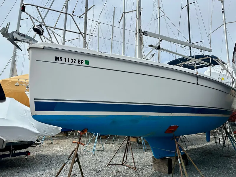 Slide: The Image of Interior of a 2006 Hunter 31 sailboat with wood finish and seating area. - 1